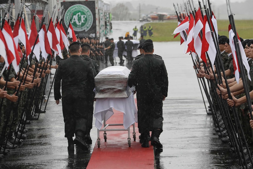 A guard of honour is formed as caskets arrive in Chapeco, Brazil.