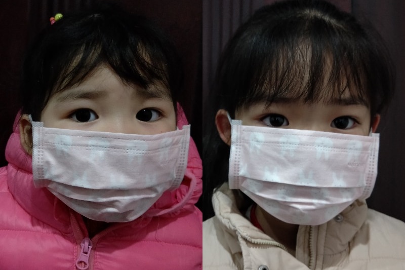 A composite image showing Hui Qiu's children, both are wearing surgical masks.