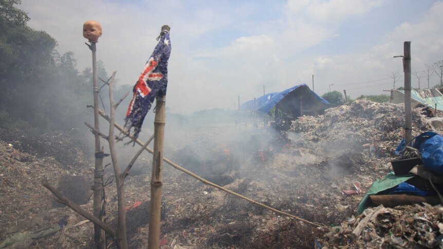 A torn Australia's flag on a pile of garbage