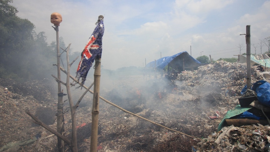 A torn Australia's flag on a pile of garbage