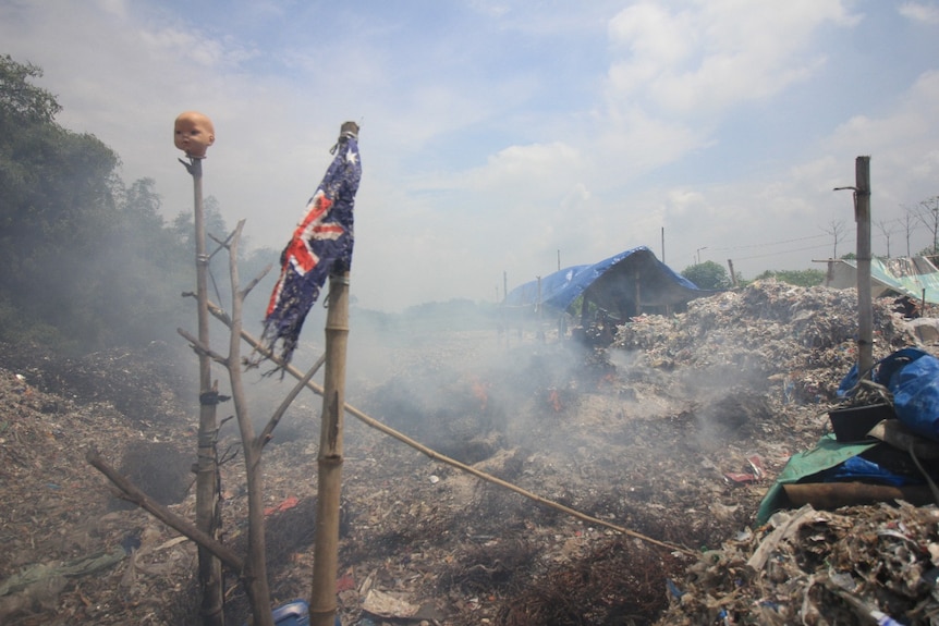 A torn Australia's flag on a pile of garbage