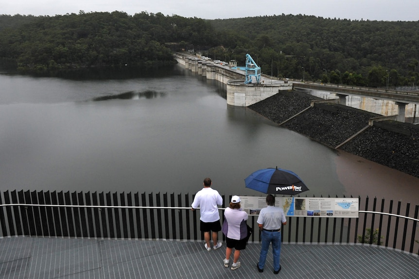 Spectators watch Warragamba Dam overflow