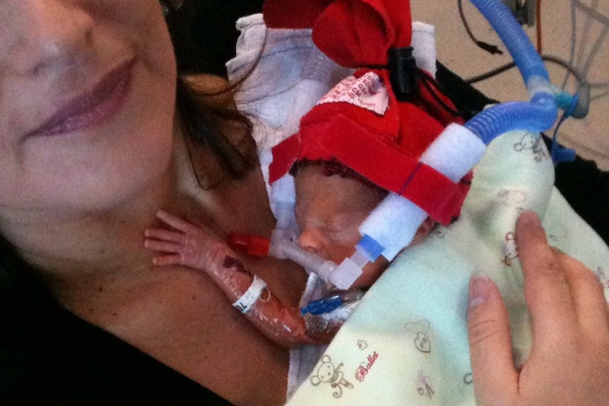 Helen holds baby John in the hospital