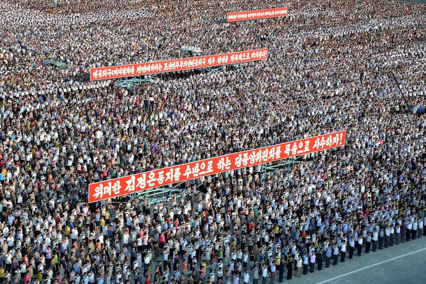 A general aerial view shows thousands of people rallying in Kim Il Sung Square.