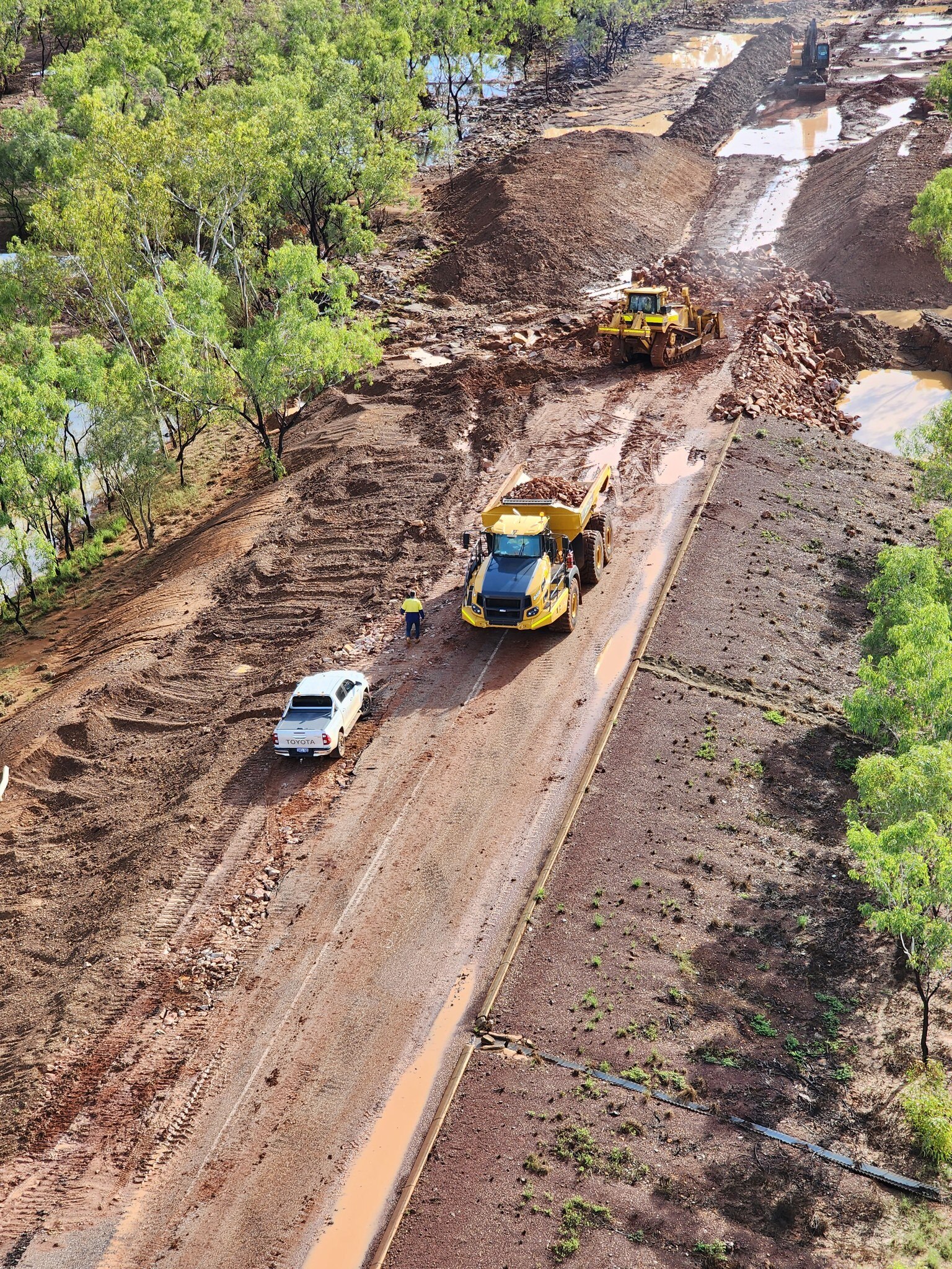 An aerial shot of trucks repairing damaged road