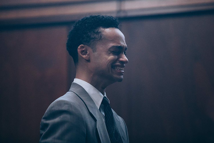 A still from the Netflix series, When They See Us, showing a young, black man crying in court.