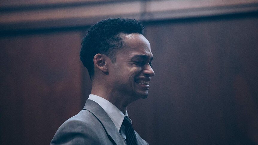 A still from the Netflix series, When They See Us, showing a young, black man crying in court.