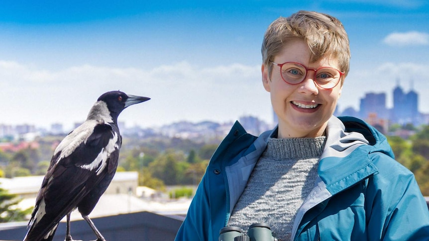 Catalyst presenter and nature journalist Dr Ann Jones with a magpie, in front of a city skyline.