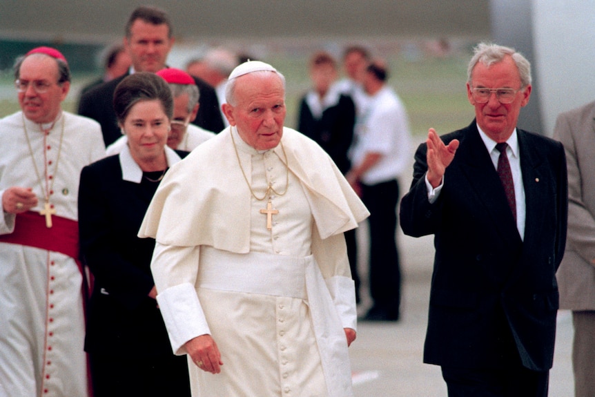 hayden waves while walking on the tarmac with pope john paull !