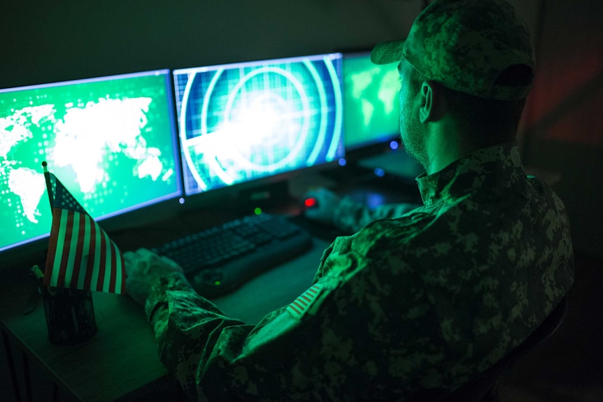 A US solider looks at computer screens in a control centre.