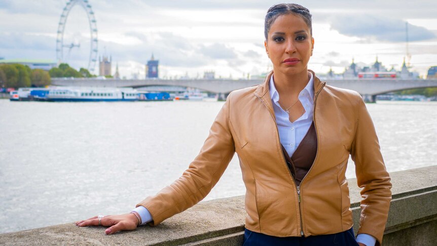 A woman in a tan leather jacket