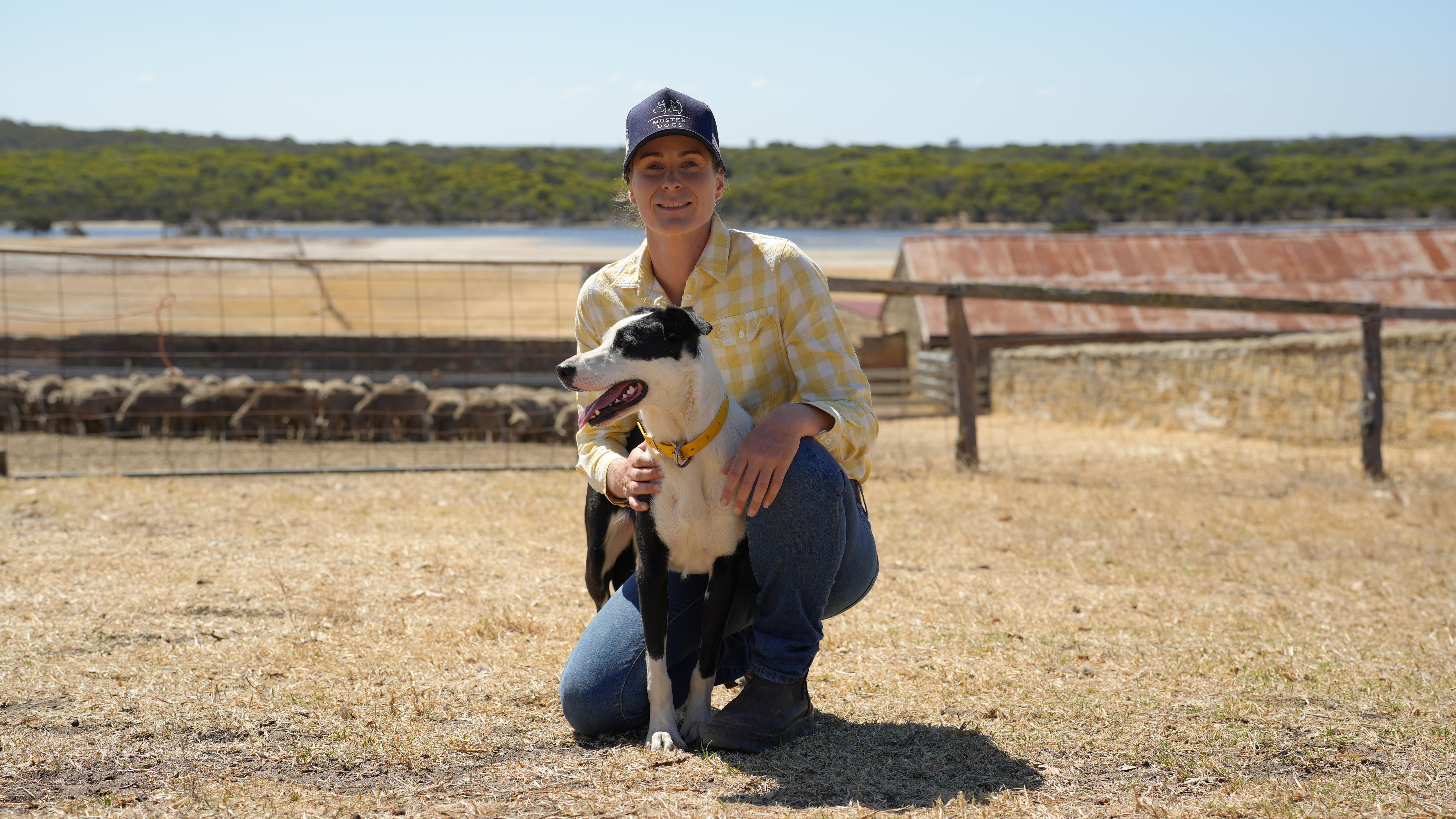 a woman posing with a dog 