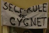 A grainy image of a hand-painted fabric sign that says 'self rule for Cygnet'