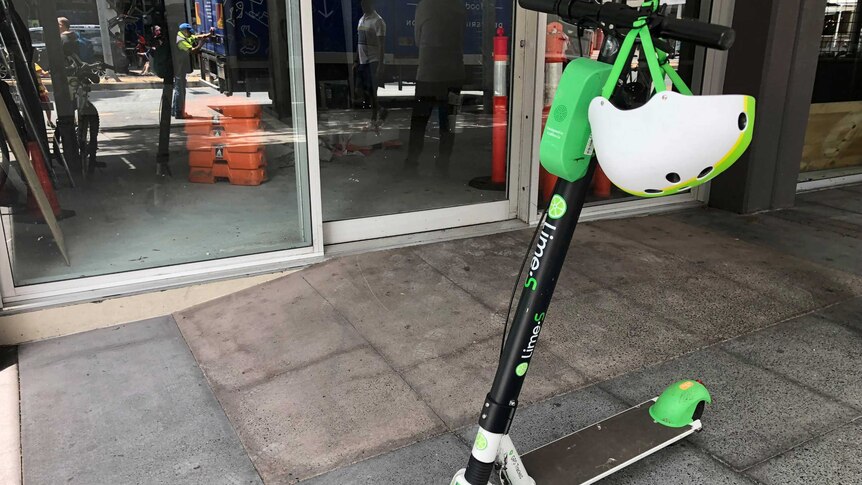 A Lime scooter parked on a sidewalk in Brisbane.