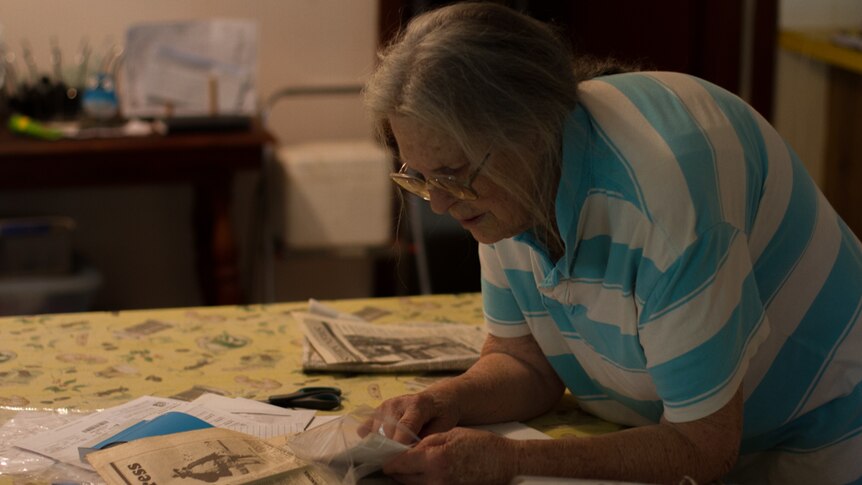 Rosarie Day searches through newspaper clippings about Banjawarn.