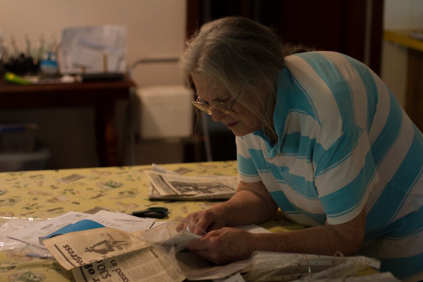Rosarie Day searches through newspaper clippings about Banjawarn.