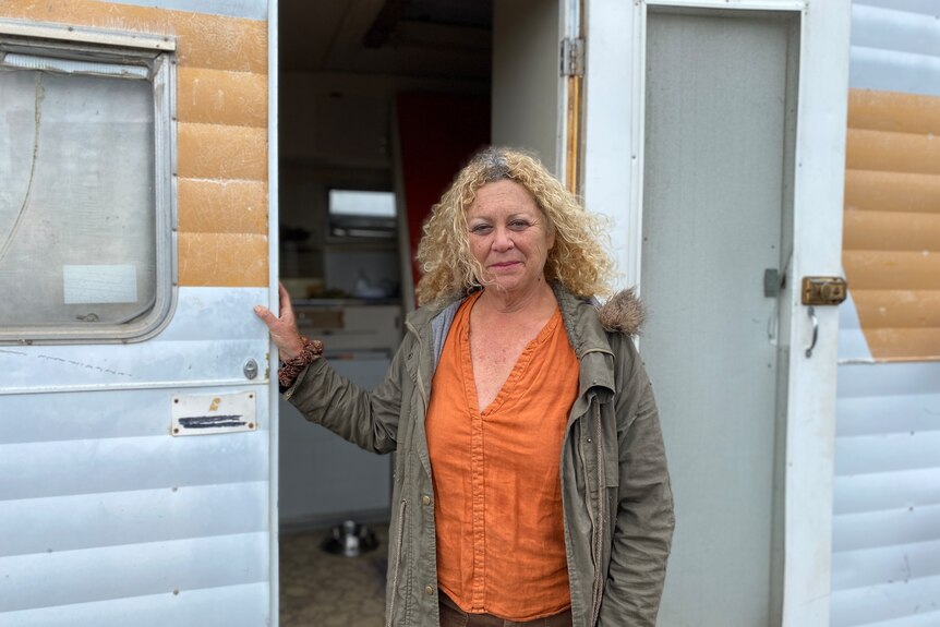woman standing in the doorway of caravan