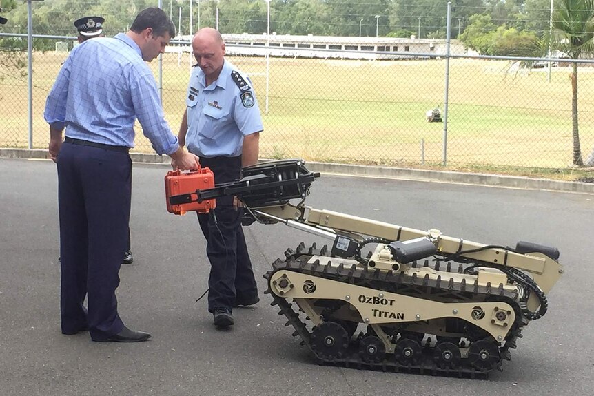 Queensland police demonstrate the OzBot Titan - a new all-terrain, life-saving robot capable of pulling victims from harm's way