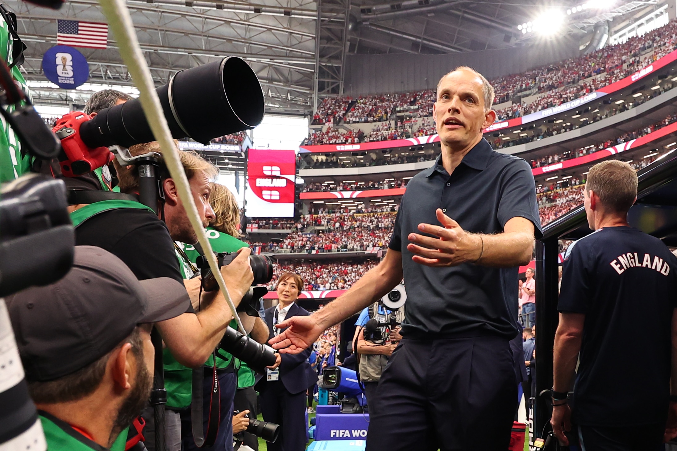Thomas Tuchel reacts towards a grounder pressure from of photographers