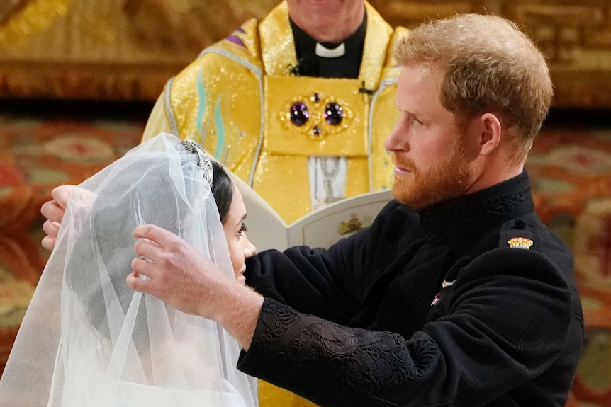 Prince Harry removes Meghan's veil.