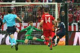 Atletico Madrid's Antione Griezmann (7) scores on Bayern Munich's Manuel Neuer in Champions League.