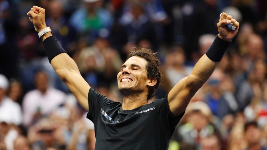 Rafael Nadal with arms outstretched celebrating his US Open win.