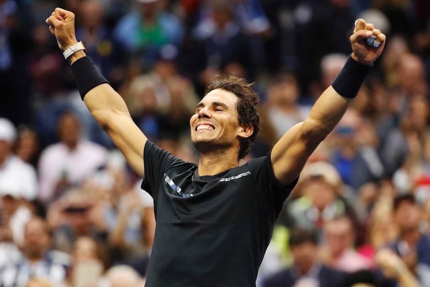 Rafael Nadal with arms outstretched celebrating his US Open win.