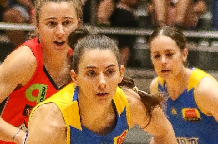 Bendigo Spirit Basketball player Tessa Lavey dribbles her ball up the court in the middle of a game.