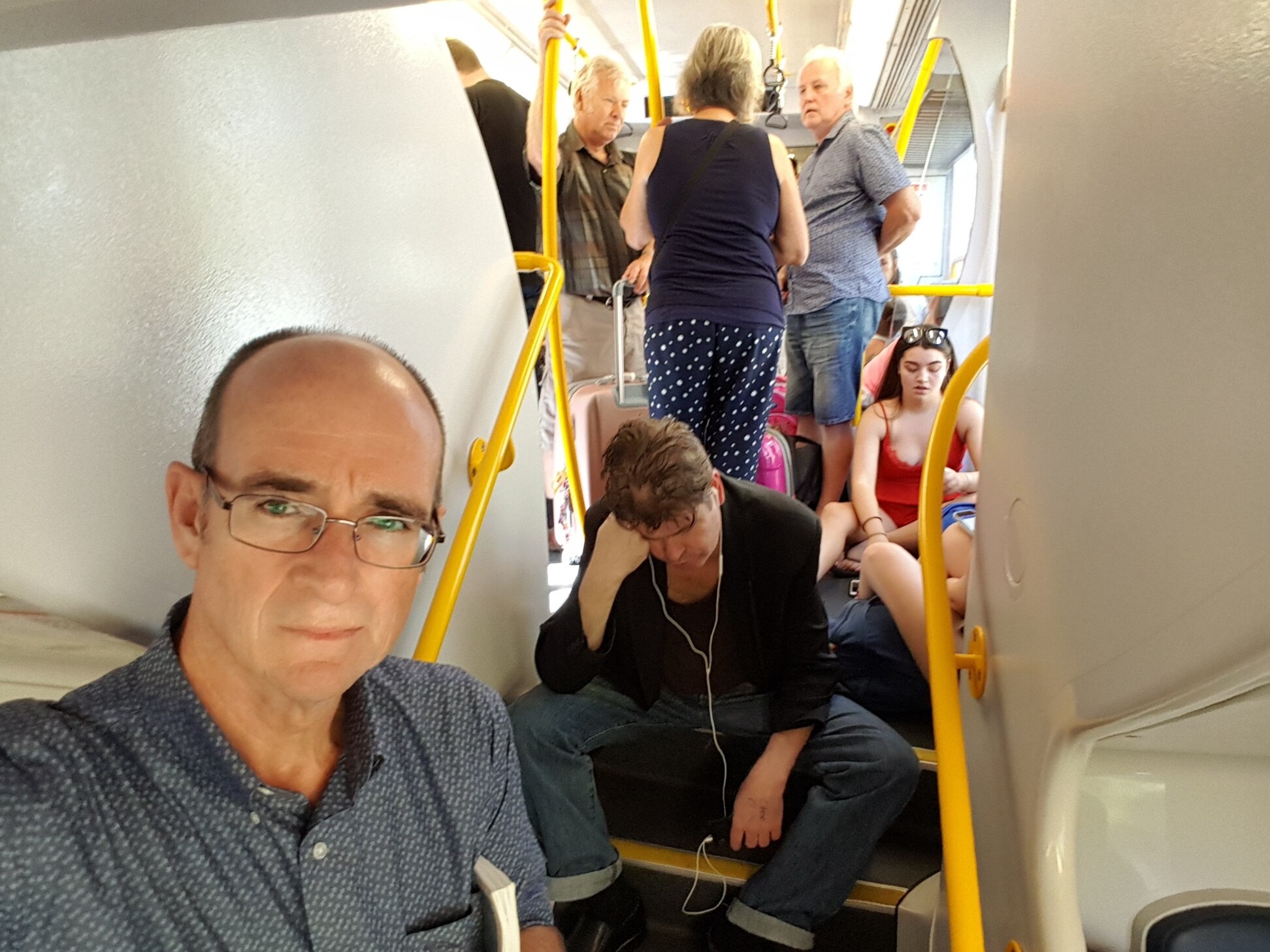 Selfie image of man on busy passenger train