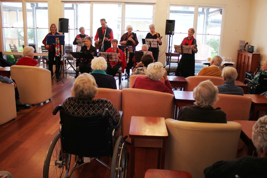 Residents enjoying a performance by the Miss Spent Ukes in Hobart.