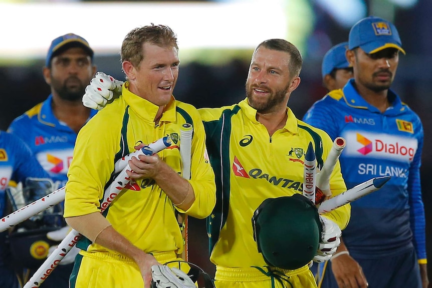 Australia's George Bailey (L) and Matthew Wade celebrate their win over Sri Lanka in Dambulla ODI.