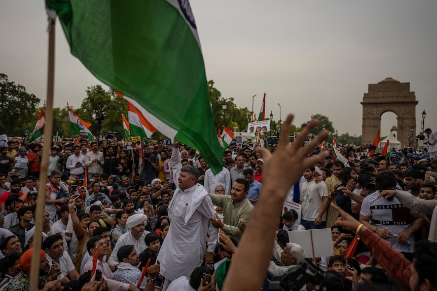 Supporters of India's top female wrestlers shout slogans in front of the landmark India Gate monument during a protest.