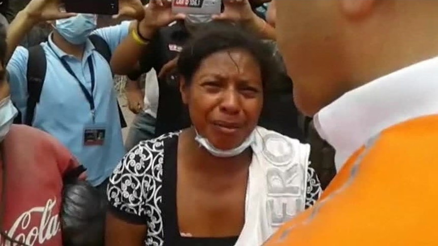 A woman begs Guatemala's leader to find her missing family members.