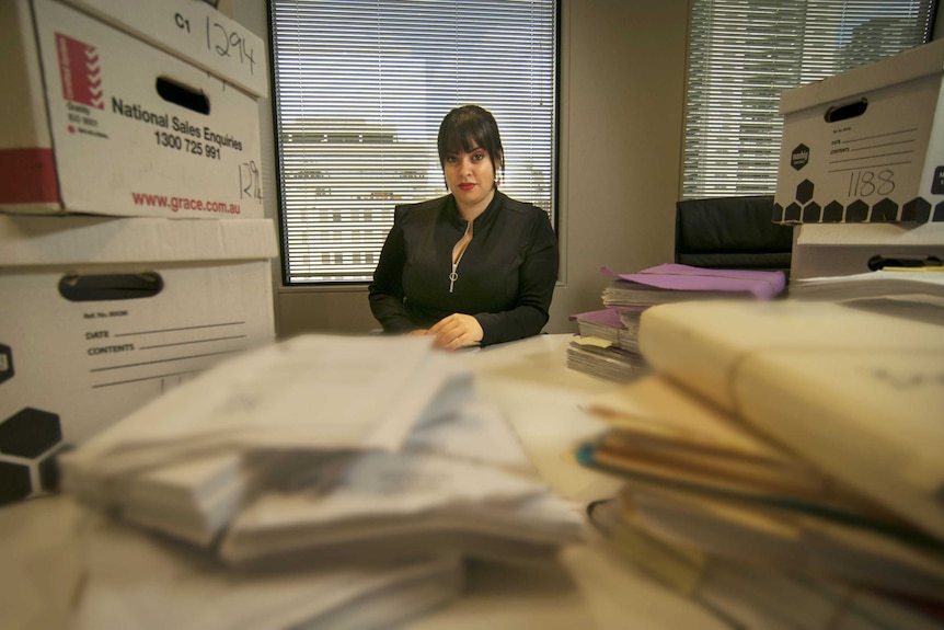 Dassi Erlich seated at a desk.