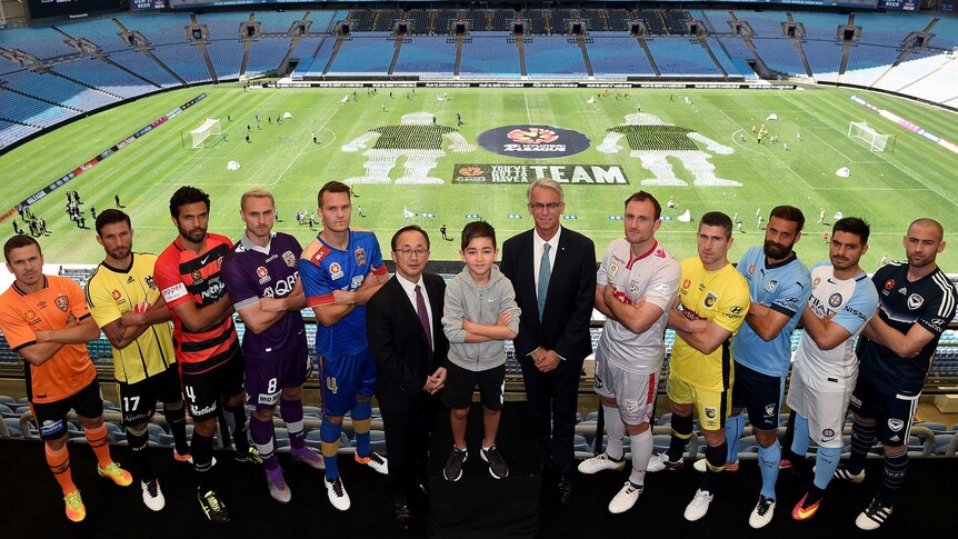 A-League players pose with Hyundai Australia chief Charlie Kim and FFA chief David Gallop in 2016.