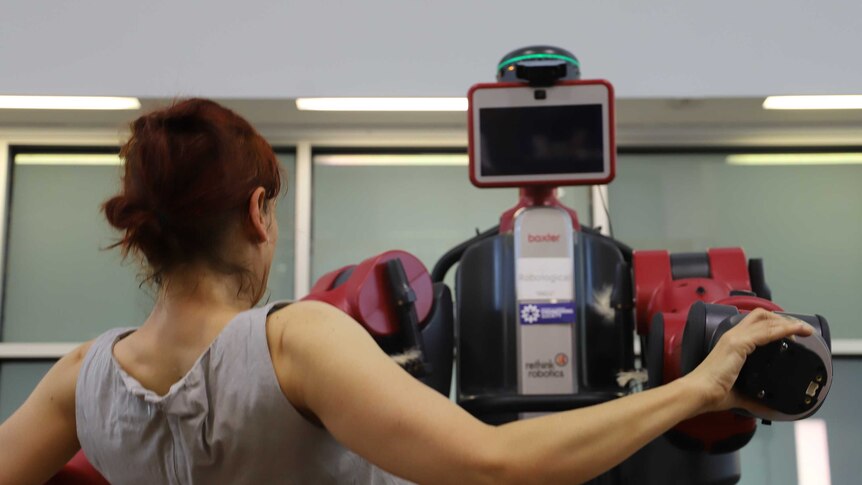 Wiradjury choreographer Vicki Van Hout teaching choreography to Baxter the robot at the University of Canberra