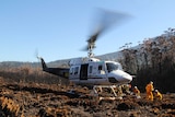 A team of Remote Area Firefighters is airlifted into a remote Tasmanian forest near a large bushfire.