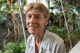 Sister Patricia Fox sitting on a verandah with tropical plants in the background. Interview for 7.30, 20 April 2018