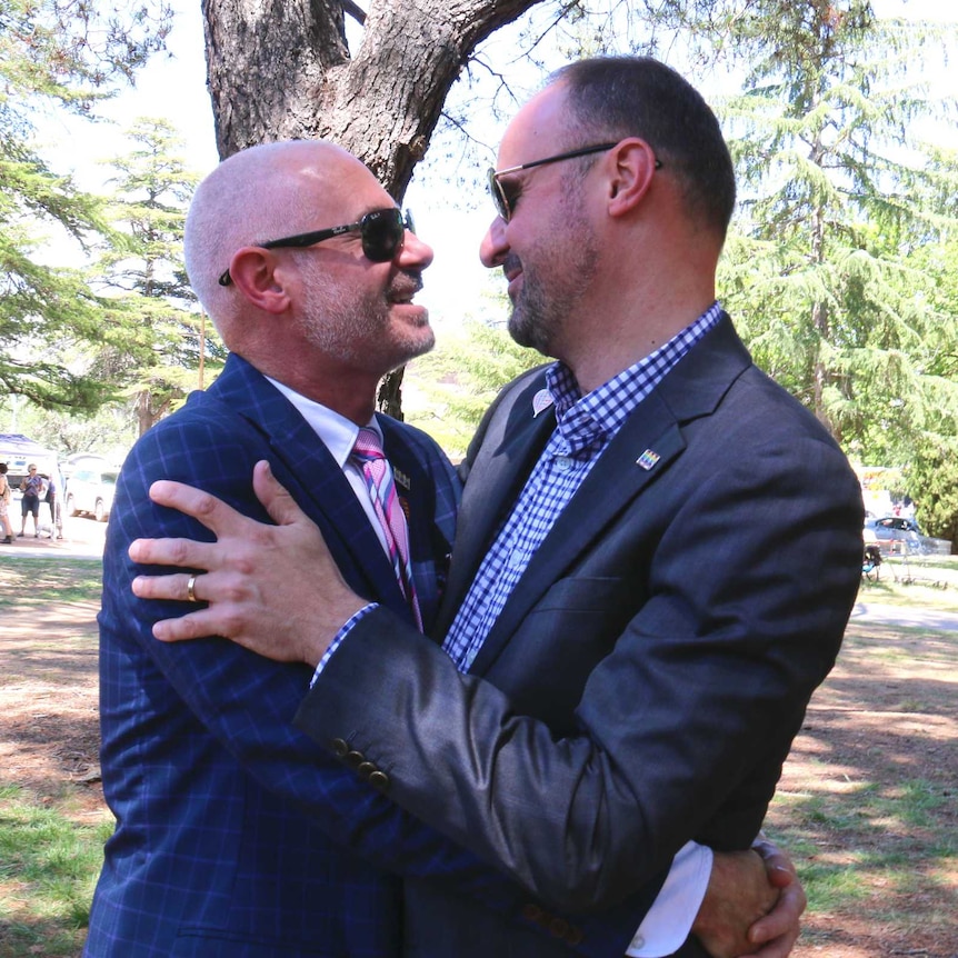 ACT Chief Minster Andrew Barr hugs his partner Anthony Toms.