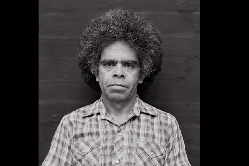 A black-and-white photograph of Uncle Jack Charles, looking serious.