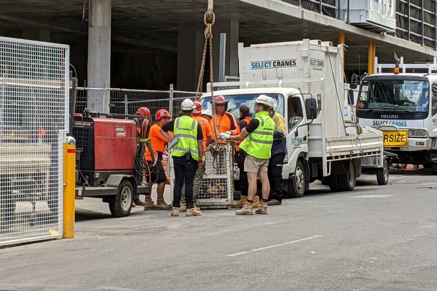 Construction workers meet on a worksite in Richmond.