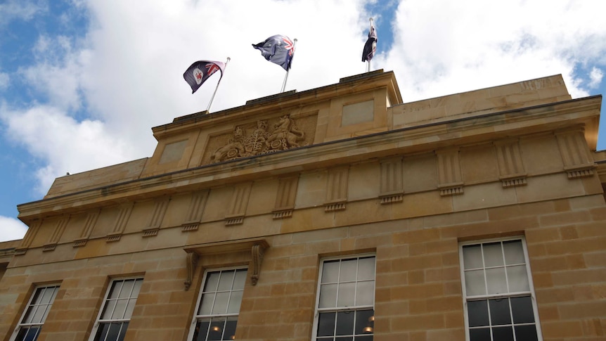 Flags fly atop Parliament House in Hobart.