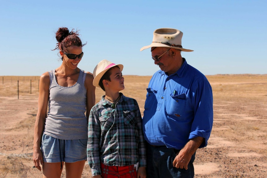 Mithaka traditional elder George Gorringe smiles with his daughter Dale and grandson Tana.