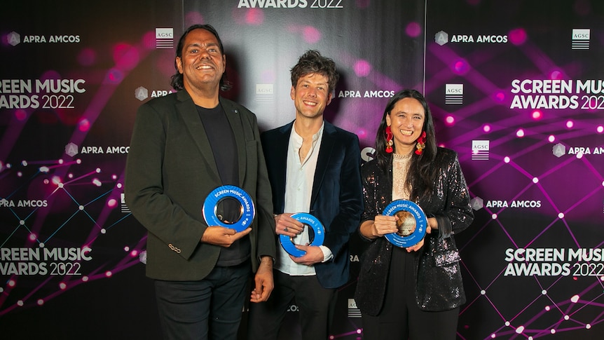 William Barton, Piers Burbrook de Vere Caitlin Yeo hold their awards at the 2022 Screen Music Awards. 