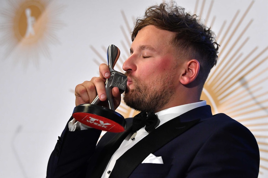 Dylan Alcott is seen kissing the Logie as most popular new talent.