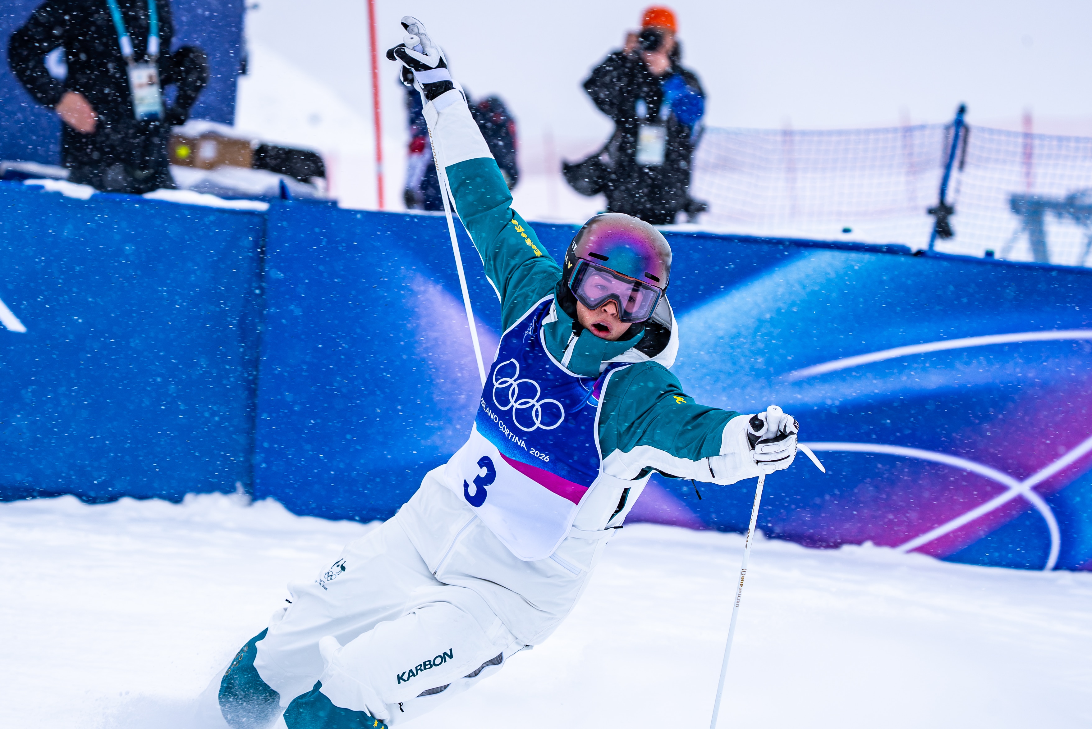 A female skiier slides to a halt on an Olympic snow track.