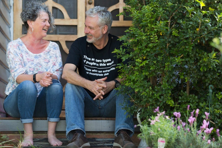 Anxiety sufferer Xenia shares a laugh on the stoop with her husband Paul.