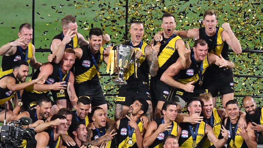 Richmond celebrates on the winners' podium after winning the AFL grand final against Geelong at the Gabba