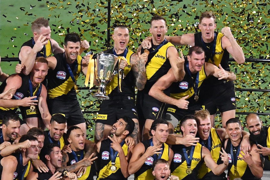 Richmond celebrates on the winners' podium after winning the AFL grand final against Geelong at the Gabba