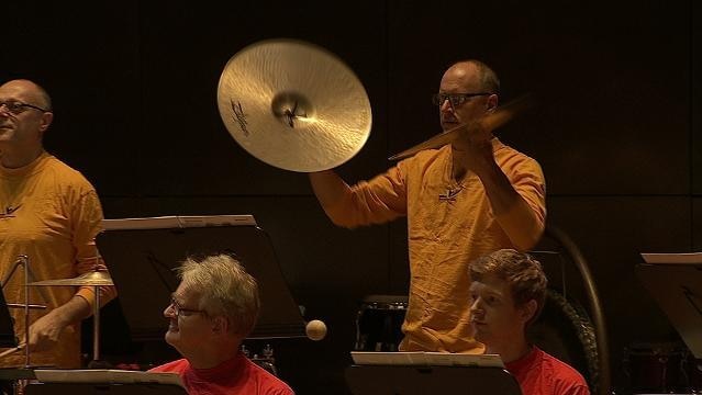 Musicians holds cymbals in orchestra pit